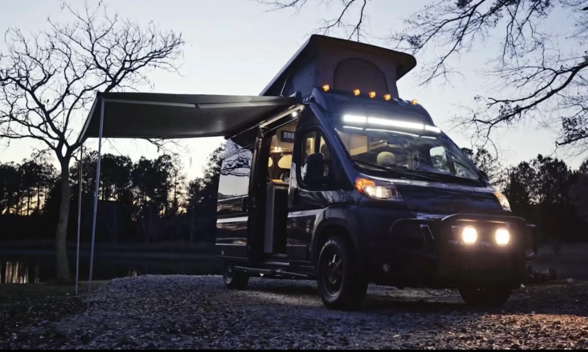 Scamper Van camping at night with lights
